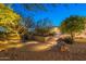 Beautiful backyard oasis with an outdoor kitchen, desert landscaping, and enchanting lighting at 6069 E Ironwood Dr, Scottsdale, AZ 85266