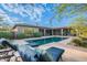 Backyard pool surrounded by patio space and comfortable lounge seating at 6069 E Ironwood Dr, Scottsdale, AZ 85266