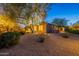 Charming backyard featuring desert landscaping, and an illuminated mature tree at 6069 E Ironwood Dr, Scottsdale, AZ 85266