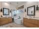 Bright bathroom with dual vanities, pendant lighting, soaking tub, and modern finishes at 6069 E Ironwood Dr, Scottsdale, AZ 85266