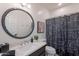 Bathroom featuring a modern vanity, updated fixtures, and patterned shower curtain at 6069 E Ironwood Dr, Scottsdale, AZ 85266