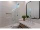 Bright bathroom featuring a glass shower, decorative plant, and a framed mirror at 6069 E Ironwood Dr, Scottsdale, AZ 85266