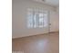 Bedroom with wood floors, large window and neutral color palette at 6069 E Ironwood Dr, Scottsdale, AZ 85266
