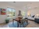 Bright bedroom featuring large windows, a ceiling fan, wood floors, and an ensuite bathroom at 6069 E Ironwood Dr, Scottsdale, AZ 85266