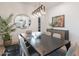 This dining room features modern lighting, a decorative mirror and is perfect for entertaining guests at 6069 E Ironwood Dr, Scottsdale, AZ 85266