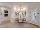 Cozy dining room features stylish lighting and a door to a patio with plenty of natural light at 6069 E Ironwood Dr, Scottsdale, AZ 85266