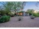 Home exterior with neutral stucco, mature desert landscaping, and a gravel yard at 6069 E Ironwood Dr, Scottsdale, AZ 85266