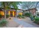 Charming front entrance with stone accents, mature trees, and desert-friendly landscaping at 6069 E Ironwood Dr, Scottsdale, AZ 85266