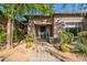 Inviting front entrance with stone accents, desert landscaping, and a covered porch at 6069 E Ironwood Dr, Scottsdale, AZ 85266