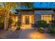 Charming front entrance with stone accents, desert landscaping, and welcoming pathway lighting at 6069 E Ironwood Dr, Scottsdale, AZ 85266