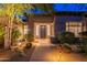 Inviting front entrance with stone accents, manicured landscaping, and a well-lit walkway at 6069 E Ironwood Dr, Scottsdale, AZ 85266