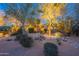 Beautiful home exterior with desert landscaping and dramatic lighting, creating an inviting curb appeal at 6069 E Ironwood Dr, Scottsdale, AZ 85266