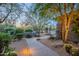 Well-manicured front yard with desert landscaping, a paved walkway, and pathway lighting at 6069 E Ironwood Dr, Scottsdale, AZ 85266