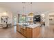 Spacious kitchen island with stainless steel sink, pendant lighting, and open view to living and dining areas at 6069 E Ironwood Dr, Scottsdale, AZ 85266