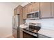 Kitchen featuring stainless steel appliances, granite countertops, and updated cabinetry at 6069 E Ironwood Dr, Scottsdale, AZ 85266