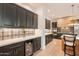Modern kitchen includes custom cabinetry, granite countertops, a wine cooler, and stainless appliances at 6069 E Ironwood Dr, Scottsdale, AZ 85266