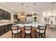 Spacious kitchen features an island with seating, stainless steel appliances, and stylish pendant lighting at 6069 E Ironwood Dr, Scottsdale, AZ 85266
