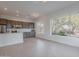 Bright, open-concept living area featuring backyard and desert views from the oversized windows at 6069 E Ironwood Dr, Scottsdale, AZ 85266
