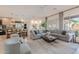 Open-concept living room with a cozy seating area, modern decor, and seamless flow to the kitchen and dining at 6069 E Ironwood Dr, Scottsdale, AZ 85266