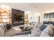 Open-concept living room with a modern fireplace, built-in shelving, and comfortable seating at 6069 E Ironwood Dr, Scottsdale, AZ 85266