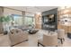 This spacious living room boasts ample seating, a sleek fireplace, and backyard views at 6069 E Ironwood Dr, Scottsdale, AZ 85266