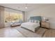Bright main bedroom featuring a lounge, ceiling fan, and outdoor views at 6069 E Ironwood Dr, Scottsdale, AZ 85266