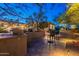 Outdoor kitchen with grill and seating area, surrounded by desert landscaping and charming lighting at 6069 E Ironwood Dr, Scottsdale, AZ 85266