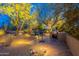Charming outdoor kitchen with a built-in grill, bar seating, and mature trees for shade at 6069 E Ironwood Dr, Scottsdale, AZ 85266
