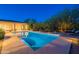 Inviting pool with sun loungers and lush desert landscaping; perfect for relaxation and entertaining at 6069 E Ironwood Dr, Scottsdale, AZ 85266
