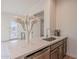 Wet bar featuring quartz countertops, modern fixtures, and stainless steel dishwasher at 6069 E Ironwood Dr, Scottsdale, AZ 85266