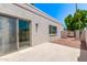 A sun-drenched back patio with desert landscaping, a slider to the home's interior, and tile flooring at 6119 E Sandra Ter, Scottsdale, AZ 85254