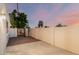 Private backyard featuring a tiled patio, desert landscaping, and secure block fencing at 6119 E Sandra Ter, Scottsdale, AZ 85254
