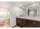 Bathroom featuring dual sinks, ample counter space, and a glass-enclosed shower and soaking tub at 6119 E Sandra Ter, Scottsdale, AZ 85254