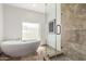 Modern bathroom with a freestanding tub, glass-enclosed shower, and tile accents at 6119 E Sandra Ter, Scottsdale, AZ 85254