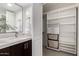Chic bathroom with a marble countertop, modern vanity, and mirrored accent wall along with closet at 6119 E Sandra Ter, Scottsdale, AZ 85254