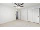 Bright bedroom with neutral carpet, ceiling fan, and closet with sliding doors at 6119 E Sandra Ter, Scottsdale, AZ 85254