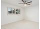 Bright bedroom featuring neutral carpet, ceiling fan, and window with shutters at 6119 E Sandra Ter, Scottsdale, AZ 85254