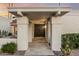 Front entryway with double doors, stone tile, stucco columns, and manicured landscaping at 6119 E Sandra Ter, Scottsdale, AZ 85254