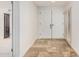 Foyer featuring stone tile flooring, a double-door closet, and shuttered window at 6119 E Sandra Ter, Scottsdale, AZ 85254