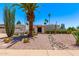 Charming home featuring desert landscaping with a large palm tree and rock accents at 6119 E Sandra Ter, Scottsdale, AZ 85254