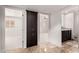 Hallway featuring tile flooring, a built-in cabinet, and access to the rooms at 6119 E Sandra Ter, Scottsdale, AZ 85254