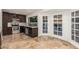 Bright kitchen featuring stainless steel appliances, dark wood cabinets, and stylish tile backsplash at 6119 E Sandra Ter, Scottsdale, AZ 85254