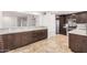 Kitchen featuring tile floors, stainless appliances, and dark cabinets at 6119 E Sandra Ter, Scottsdale, AZ 85254