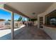 Covered outdoor living space with BBQ grill, kitchen and bar, with stone flooring at 6119 E Sandra Ter, Scottsdale, AZ 85254