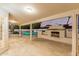 Covered patio featuring an outdoor fireplace, with view of the pool and backyard area at 6119 E Sandra Ter, Scottsdale, AZ 85254