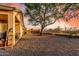 Desert backyard landscaped with gravel groundcover, mature tree, block wall, and decorative iron view fence at 6520 E Hacienda La Noria Ln, Gold Canyon, AZ 85118