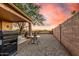 Charming backyard with desert landscaping, an outdoor grill, and seating area at 6520 E Hacienda La Noria Ln, Gold Canyon, AZ 85118