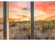 Backyard view with desert landscape and sunset framed by a metal fence at 6520 E Hacienda La Noria Ln, Gold Canyon, AZ 85118