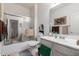 Neutral bathroom with a tiled floor, shower with glass door, vanity with mirror and cabinets at 6520 E Hacienda La Noria Ln, Gold Canyon, AZ 85118