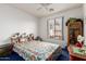 Bedroom featuring a ceiling fan, window with a view, and shelving displaying photos and decorations at 6520 E Hacienda La Noria Ln, Gold Canyon, AZ 85118